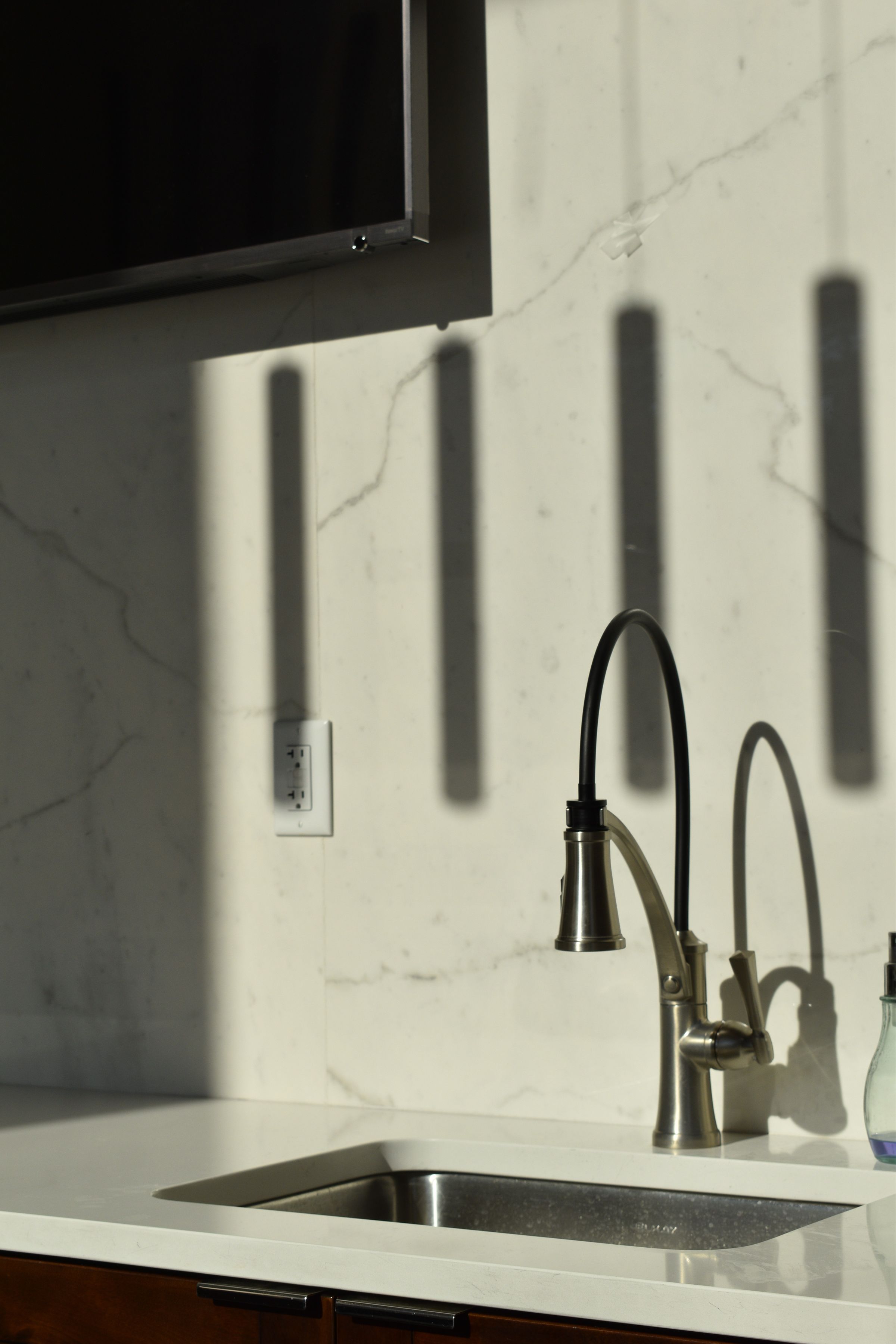 Configured sink and faucet combination in a bright kitchen setting